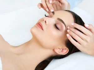Face Massage. Close-up of a Young Woman Getting Spa Treatment.