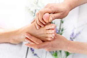 39062500 – reflexology. woman in a beauty salon for pedicure and foot massage.